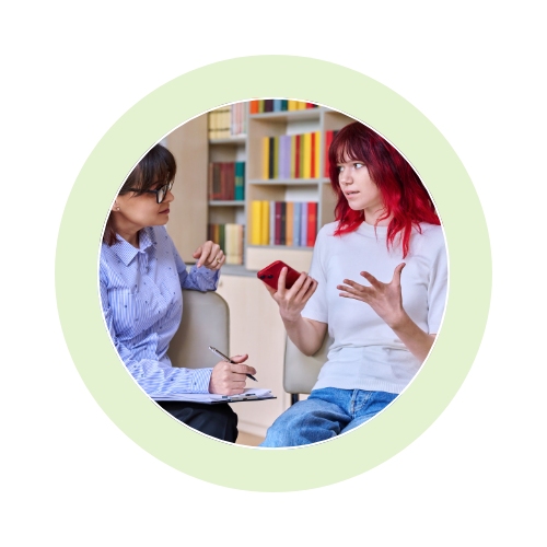 Two women engaged in a deep conversation in a cozy room.