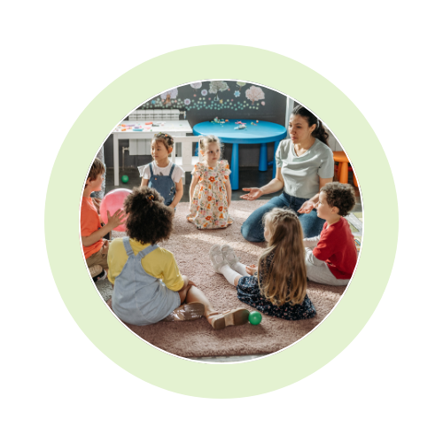 Children and teacher sitting in a circle.