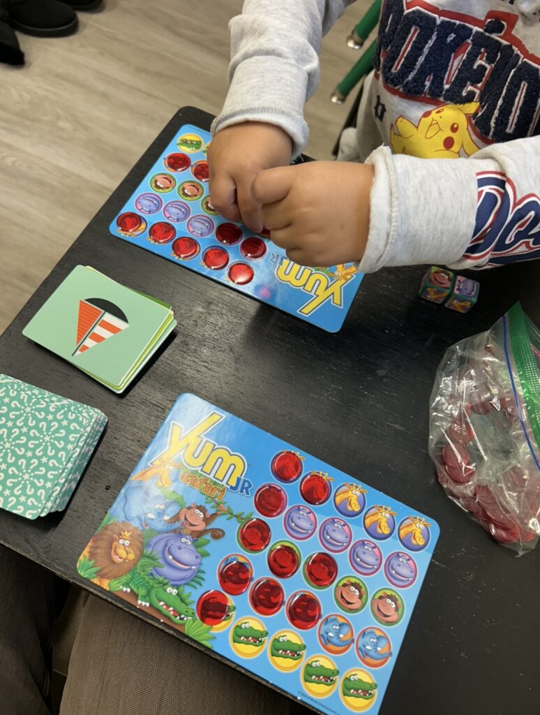 Children playing a fun bingo game with colorful cards and chips.